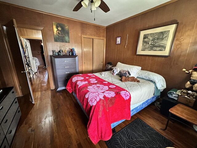 4440 W Iowa St, Chicago, IL 60651 - bedroom featuring wood-type flooring, a closet, wooden walls, and ceiling fan