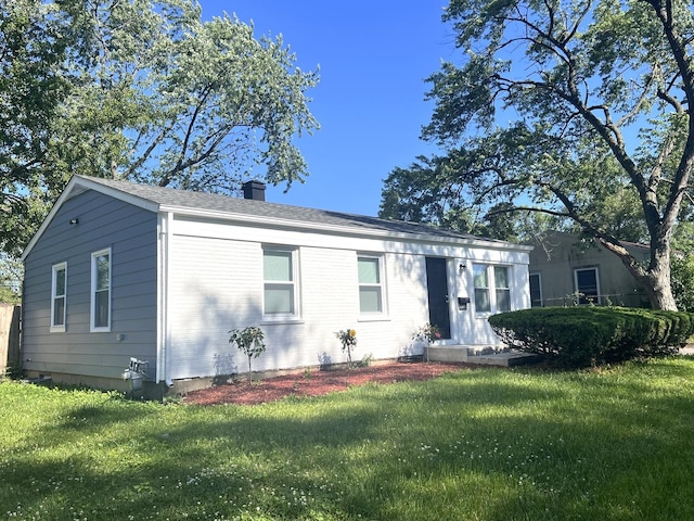 21655 Clyde Ave, Sauk Village, IL 60411 - ranch-style home featuring a chimney, a front lawn, and a shingled roof