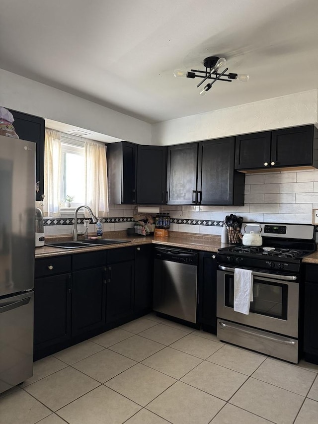 3712 W 121st St, Alsip, IL 60803 - kitchen with appliances with stainless steel finishes, dark cabinetry, and decorative backsplash