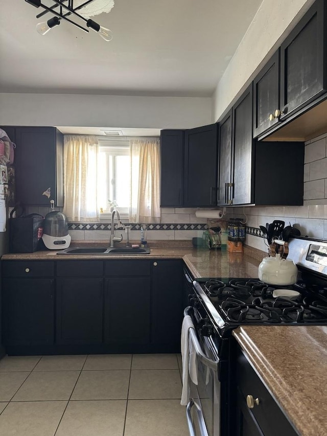 3712 W 121st St, Alsip, IL 60803 - kitchen with gas range, backsplash, light tile patterned floors, and dark countertops