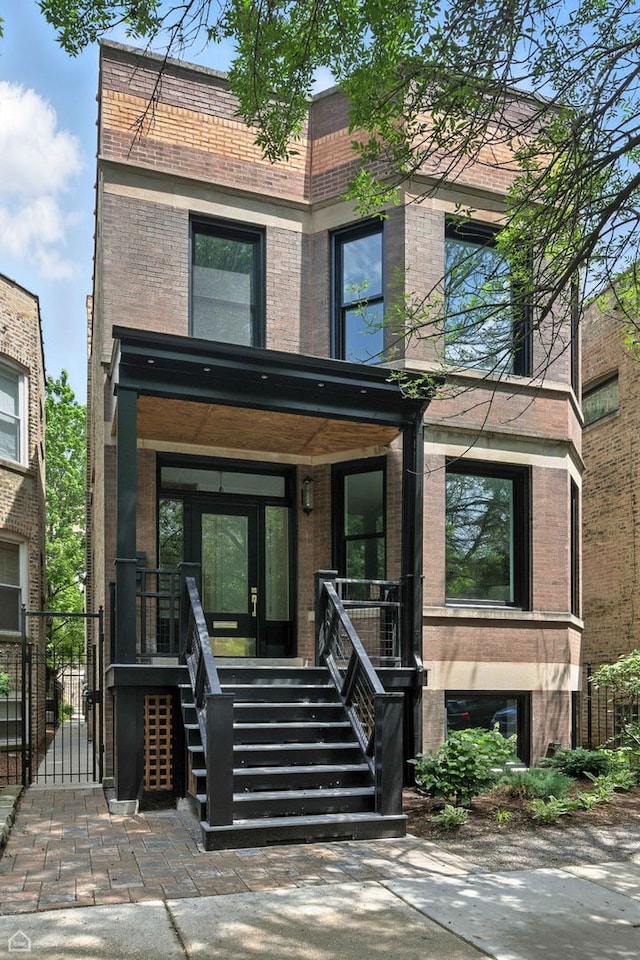 4525 N Artesian Ave, Chicago, IL 60625 - contemporary home with brick siding, a gate, and a porch