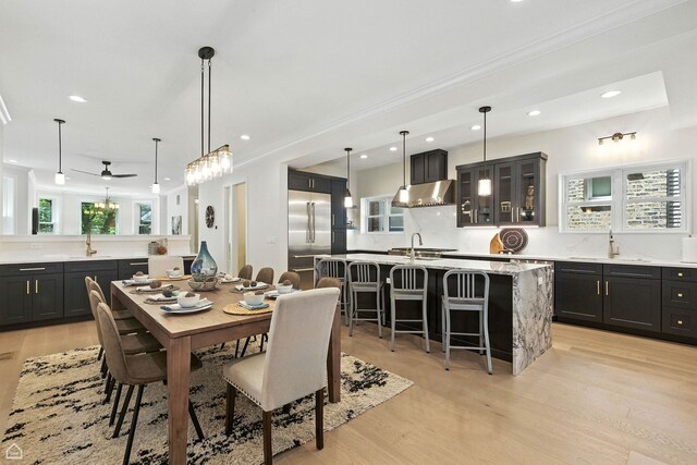 4525 N Artesian Ave, Chicago, IL 60625 - dining room featuring light wood-type flooring, recessed lighting, ornamental molding, and ceiling fan