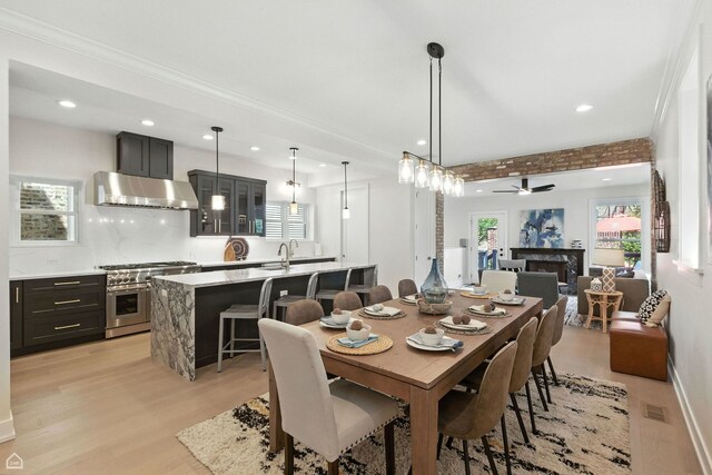 4525 N Artesian Ave, Chicago, IL 60625 - dining area with light wood-style flooring, ceiling fan, recessed lighting, and a fireplace