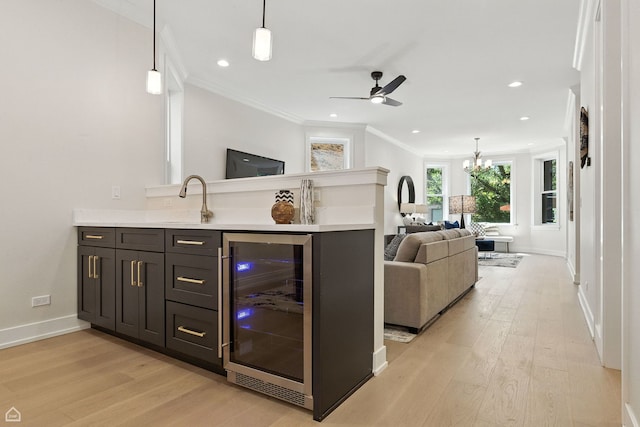 4525 N Artesian Ave, Chicago, IL 60625 - indoor bar with beverage cooler, light wood-type flooring, crown molding, ceiling fan, and a chandelier