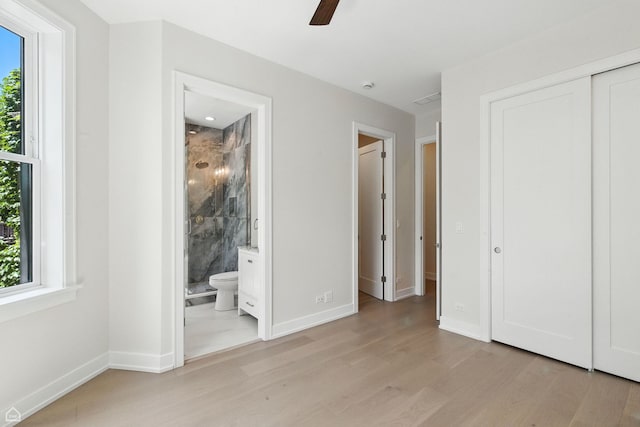 4525 N Artesian Ave, Chicago, IL 60625 - unfurnished bedroom with light wood-style floors, multiple windows, a closet, and ensuite bathroom