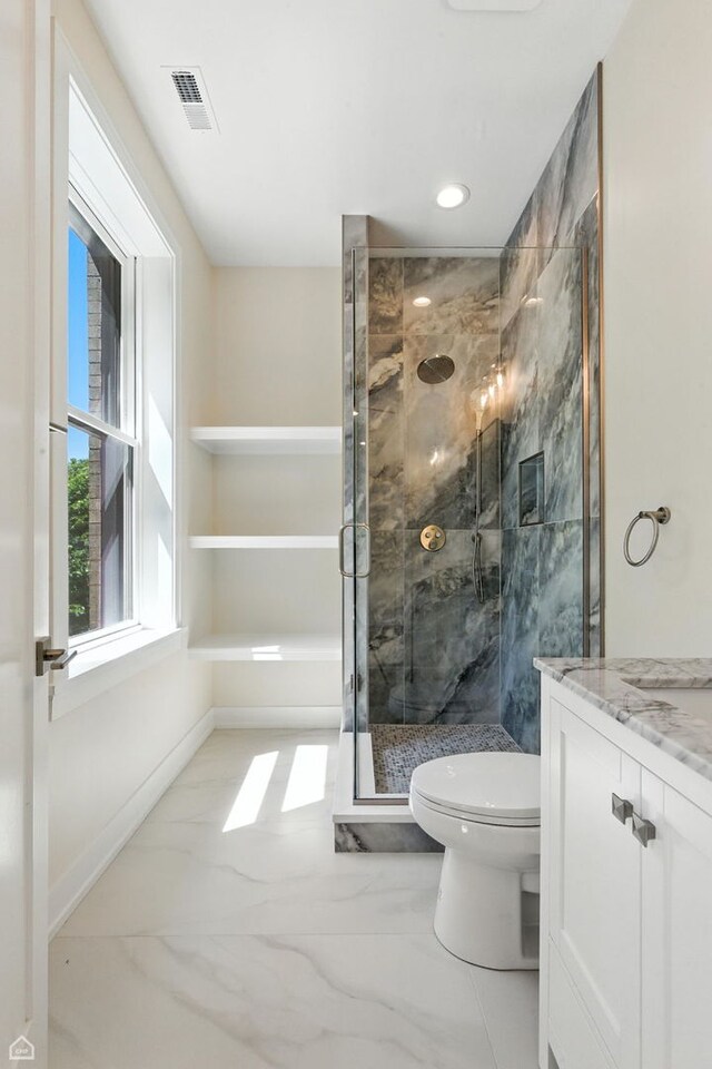 4525 N Artesian Ave, Chicago, IL 60625 - bathroom with marble look tiles, a stall shower, vanity, and recessed lighting