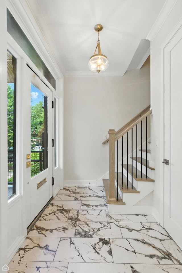 4525 N Artesian Ave, Chicago, IL 60625 - foyer entrance with plenty of natural light, marble finish flooring, stairs, and ornamental molding
