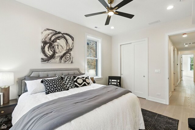 4525 N Artesian Ave, Chicago, IL 60625 - bedroom featuring light wood-style flooring, recessed lighting, a closet, and a ceiling fan