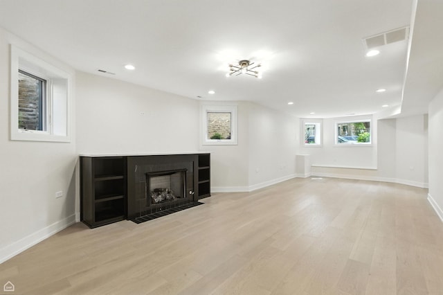 4525 N Artesian Ave, Chicago, IL 60625 - unfurnished living room with wood finished floors, recessed lighting, and a fireplace with flush hearth