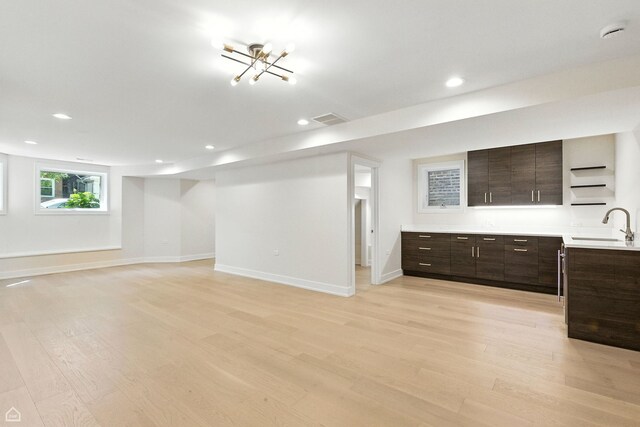 4525 N Artesian Ave, Chicago, IL 60625 - below grade area with light wood-style floors, recessed lighting, and a chandelier