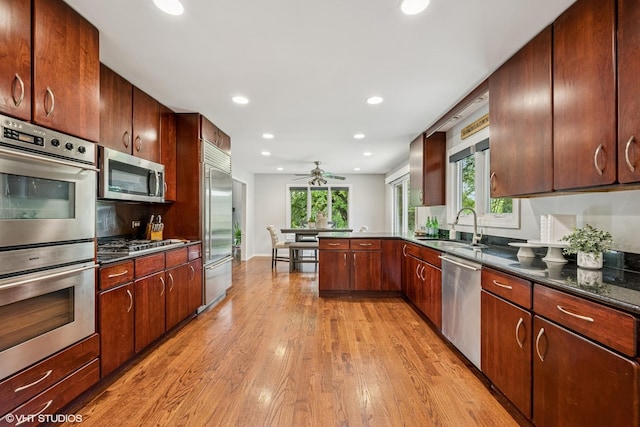 10 N Highview Cir, Hawthorn Woods, IL 60047 - kitchen featuring appliances with stainless steel finishes, light wood-style floors, healthy amount of natural light, a peninsula, and recessed lighting