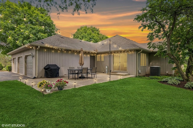 10 N Highview Cir, Hawthorn Woods, IL 60047 - back of property at dusk featuring a lawn, a shingled roof, a patio, and board and batten siding