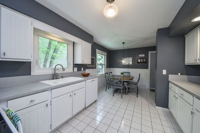 1605 Rita Ave, Saint Charles, IL 60174 - kitchen with dishwasher, a wainscoted wall, white cabinets, light countertops, and decorative light fixtures
