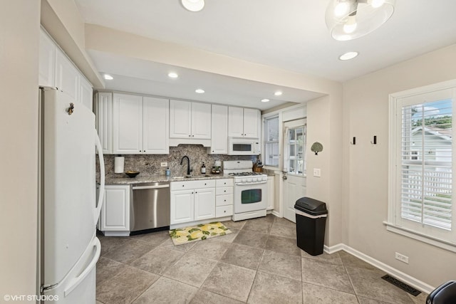8041 W 29th Ct, North Riverside, IL 60546 - kitchen with white appliances, white cabinets, tasteful backsplash, light stone counters, and recessed lighting