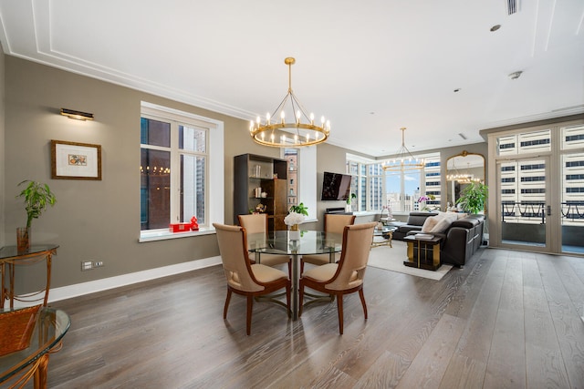 118 E Erie St Unit 21C, Chicago, IL 60611 - dining room with a chandelier, wood finished floors, and ornamental molding