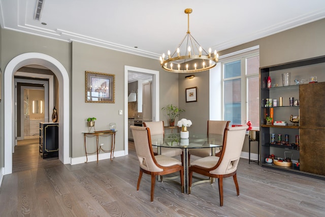 118 E Erie St Unit 21C, Chicago, IL 60611 - dining room with wood finished floors, arched walkways, and a chandelier