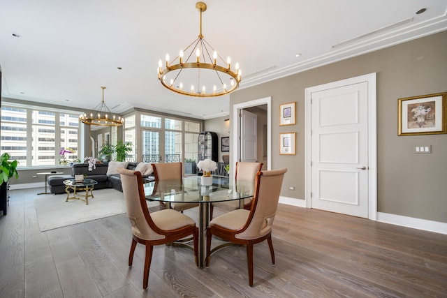 118 E Erie St Unit 21C, Chicago, IL 60611 - dining space with a chandelier, wood finished floors, and crown molding