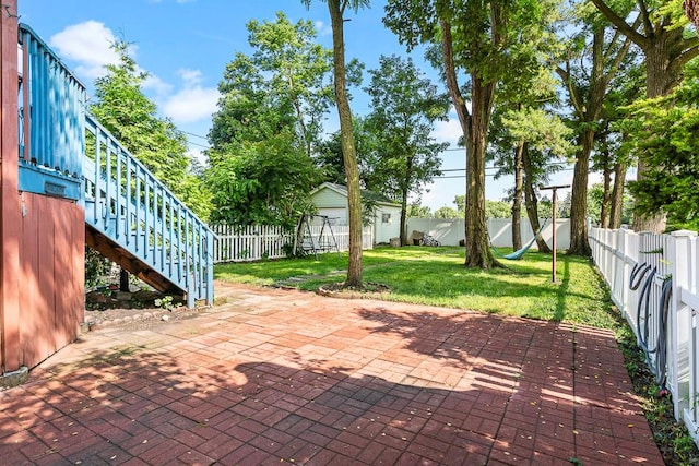8112 Christie Ave, Lyons, IL 60534 - fenced backyard featuring a patio, stairs, and an outbuilding
