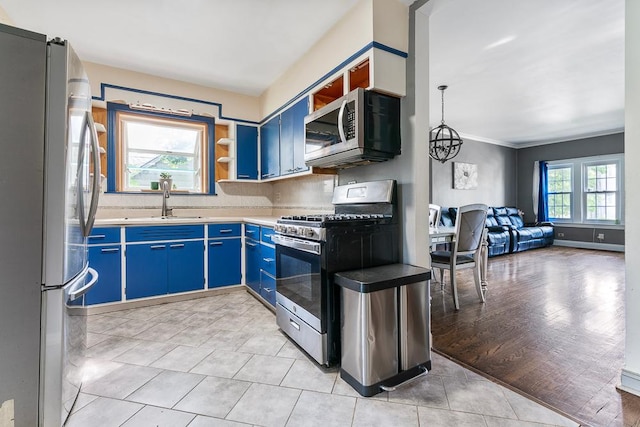 8112 Christie Ave, Lyons, IL 60534 - kitchen featuring appliances with stainless steel finishes, blue cabinets, open floor plan, backsplash, and light countertops