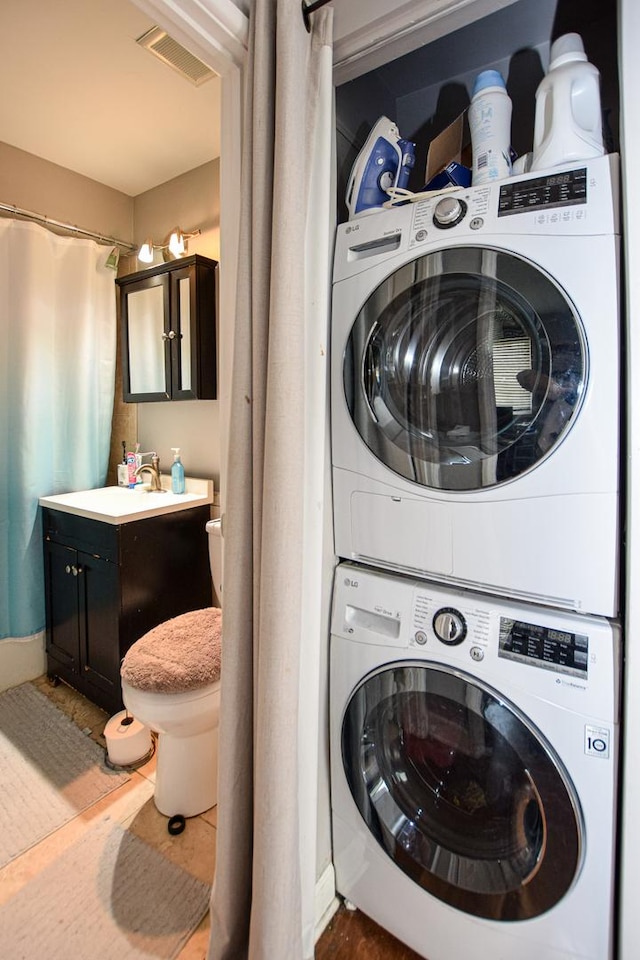 17242 71st Ct Unit 10, Tinley Park, IL 60477 - laundry area featuring stacked washer and clothes dryer and baseboards