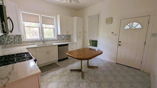 6240 S Kolmar Ave, Chicago, IL 60629 - kitchen with appliances with stainless steel finishes, backsplash, white cabinets, and healthy amount of natural light