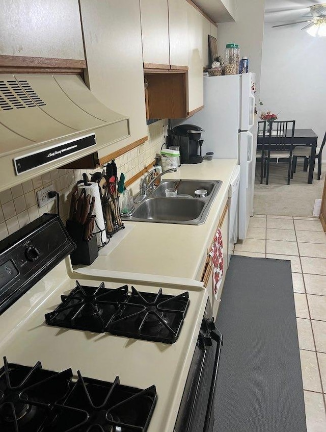 2086 Country Club Dr Unit 3F, Woodridge, IL 60517 - kitchen featuring gas range, light tile patterned floors, tasteful backsplash, and light countertops