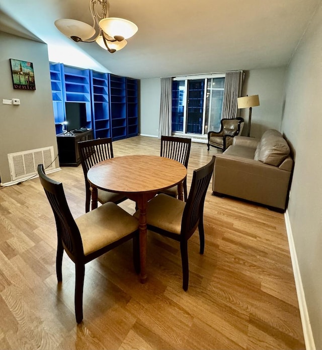 5901 N Sheridan Rd Unit 9G, Chicago, IL 60660 - dining area featuring a chandelier and light wood-type flooring