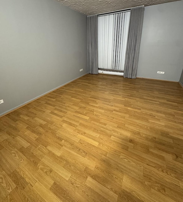 5901 N Sheridan Rd Unit 9G, Chicago, IL 60660 - spare room with light wood finished floors and a baseboard radiator