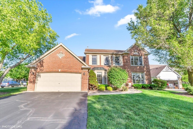 1175 Oxford Ct, Lake Zurich, IL 60047 - view of front of home with brick siding, asphalt driveway, a front lawn, and a garage