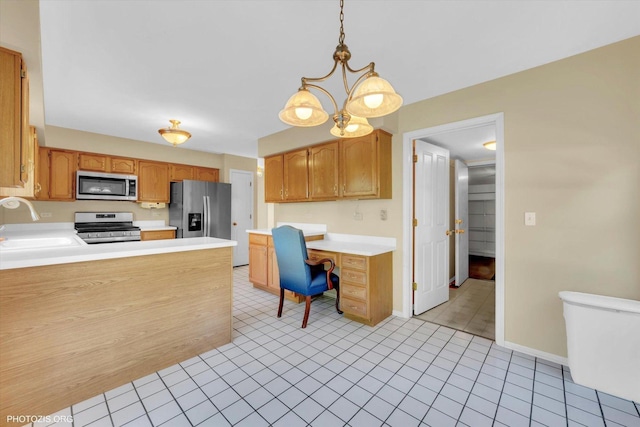 1175 Oxford Ct, Lake Zurich, IL 60047 - kitchen with stainless steel appliances, light countertops, built in study area, a peninsula, and decorative light fixtures