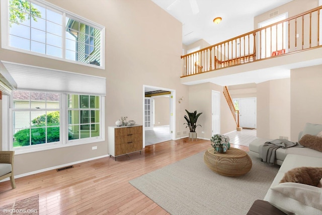 1175 Oxford Ct, Lake Zurich, IL 60047 - living room featuring stairway, a towering ceiling, and hardwood / wood-style floors