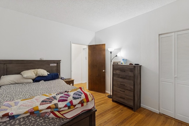 5337 S Ellis Ave Unit 1C, Chicago, IL 60615 - bedroom with light wood finished floors, a textured ceiling, and a closet