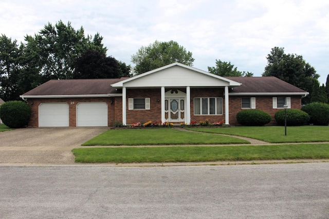 28 Manorhill Dr, Clinton, IL 61727 - ranch-style home with brick siding, a garage, and concrete driveway
