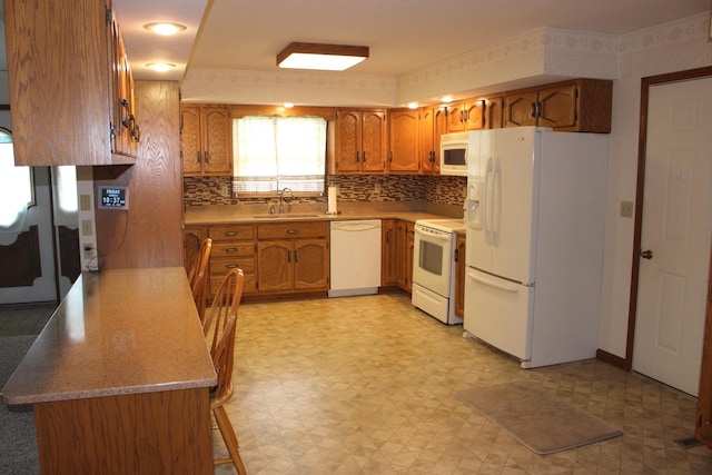 28 Manorhill Dr, Clinton, IL 61727 - kitchen featuring white appliances, light floors, brown cabinets, and backsplash