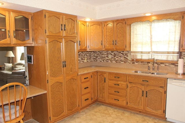 28 Manorhill Dr, Clinton, IL 61727 - kitchen with white dishwasher, light countertops, backsplash, and brown cabinets