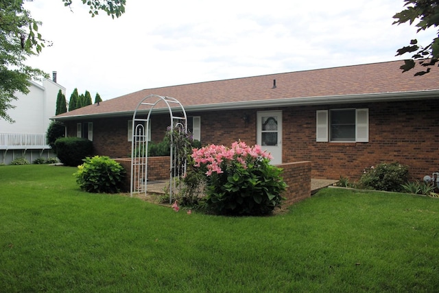 28 Manorhill Dr, Clinton, IL 61727 - back of property featuring brick siding, a lawn, and a shingled roof