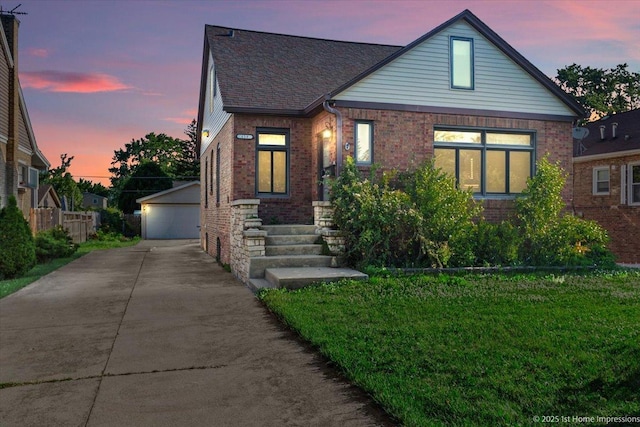 659 W Albert St, Elmhurst, IL 60126 - view of front of house with brick siding, an outdoor structure, a detached garage, and a yard