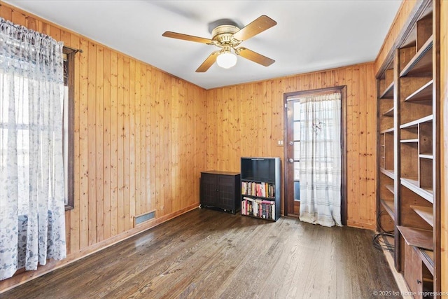 659 W Albert St, Elmhurst, IL 60126 - empty room with wooden walls, wood finished floors, and ceiling fan