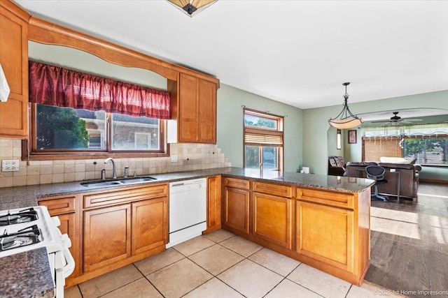659 W Albert St, Elmhurst, IL 60126 - kitchen with white appliances, a peninsula, backsplash, brown cabinets, and ceiling fan
