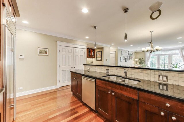 846 W Roscoe St Unit 3W, Chicago, IL 60657 - kitchen featuring dishwasher, tasteful backsplash, light wood-style floors, dark stone counters, and pendant lighting