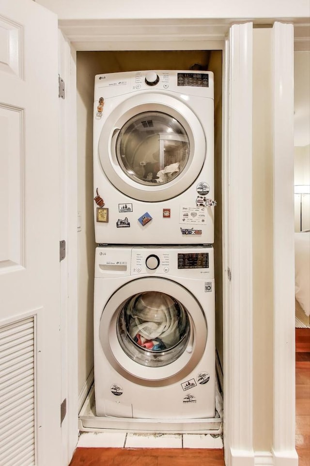 846 W Roscoe St Unit 3W, Chicago, IL 60657 - washroom with stacked washing machine and dryer and wood finished floors