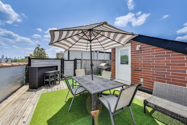 846 W Roscoe St Unit 3W, Chicago, IL 60657 - view of patio featuring outdoor dining area, a wooden deck, and a grill