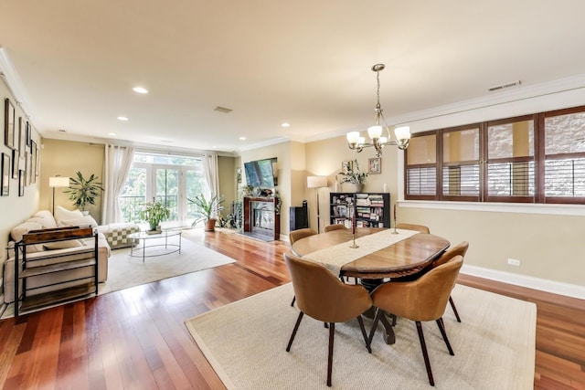 846 W Roscoe St Unit 3W, Chicago, IL 60657 - dining area with ornamental molding, a chandelier, wood finished floors, recessed lighting, and a fireplace