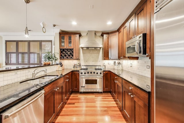 846 W Roscoe St Unit 3W, Chicago, IL 60657 - kitchen with high end appliances, wall chimney range hood, dark stone countertops, light wood-type flooring, and recessed lighting