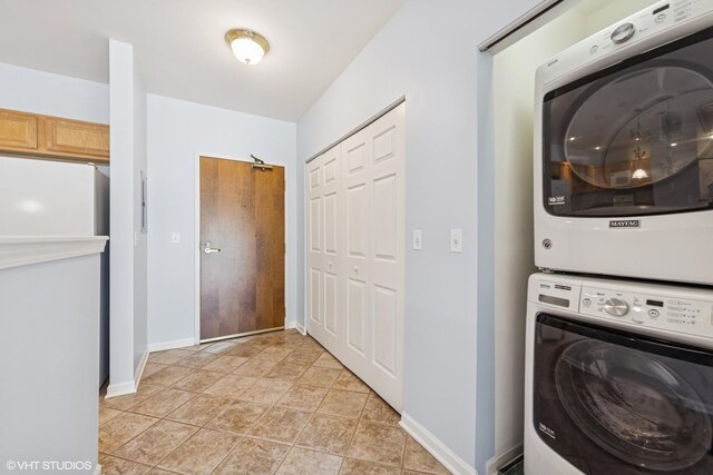 965 Rogers St Unit 202, Downers Grove, IL 60515 - laundry area with stacked washer / dryer and baseboards