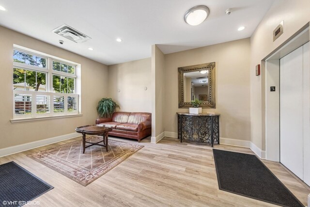 965 Rogers St Unit 202, Downers Grove, IL 60515 - sitting room featuring elevator, light wood-type flooring, and recessed lighting