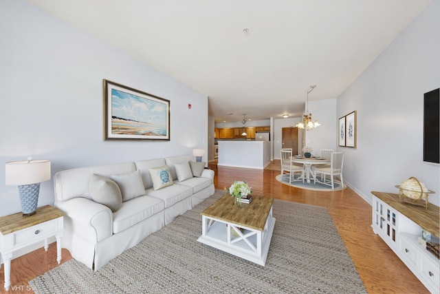 965 Rogers St Unit 202, Downers Grove, IL 60515 - living room with a chandelier and light wood-style flooring