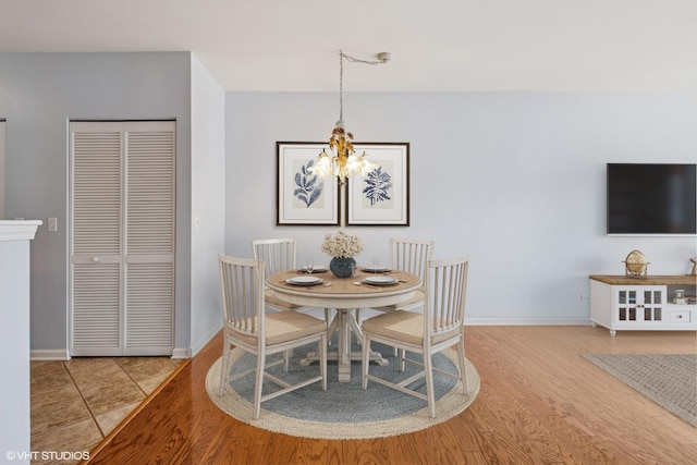 965 Rogers St Unit 202, Downers Grove, IL 60515 - dining area with a chandelier and wood finished floors