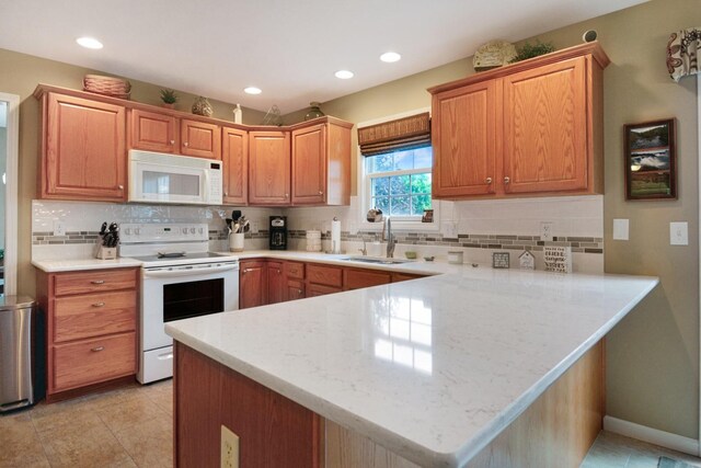 3115 Sable Oaks Rd, Bloomington, IL 61704 - kitchen with white appliances, a peninsula, backsplash, recessed lighting, and light tile patterned flooring