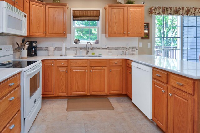3115 Sable Oaks Rd, Bloomington, IL 61704 - kitchen with white appliances, a peninsula, light countertops, backsplash, and light tile patterned flooring